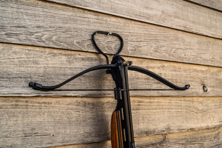 Crossbow,On,A,Wooden,Wall,With,A,Light,Vintage